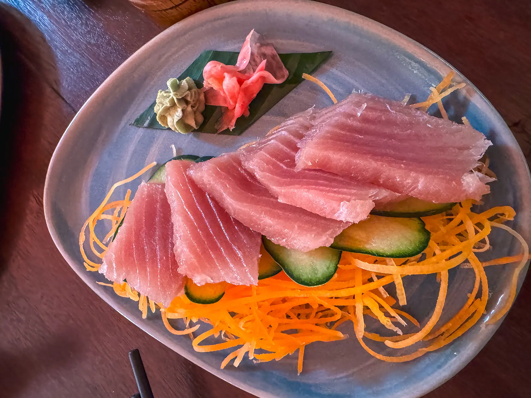 A plate of fresh tuna sashimi with cucumber and ginger at a restaurant in Nairobi, Kenya