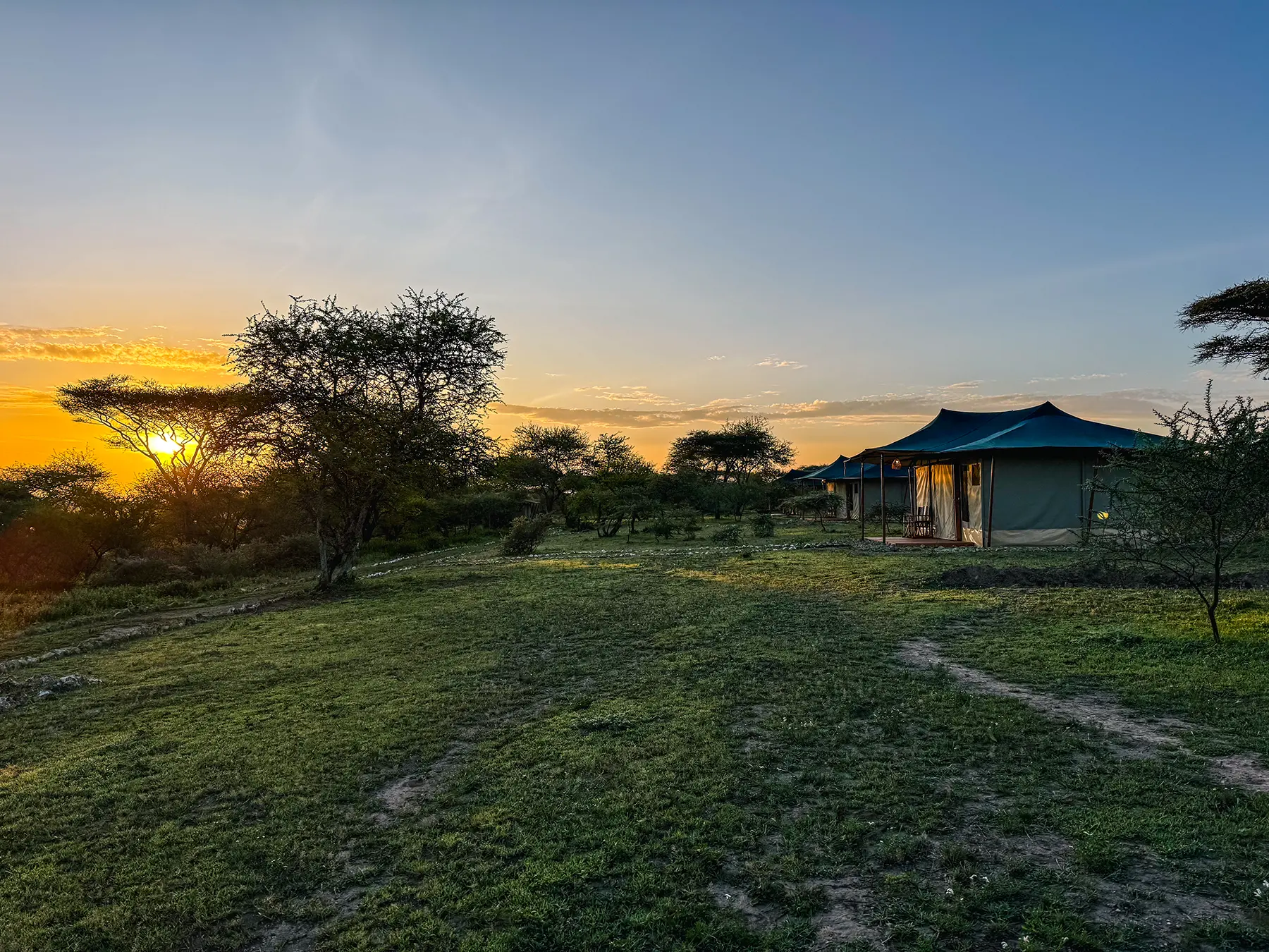 Safari tent overlooking open savanna at sunset at Ndutu, Southern Serengeti, Tanzania