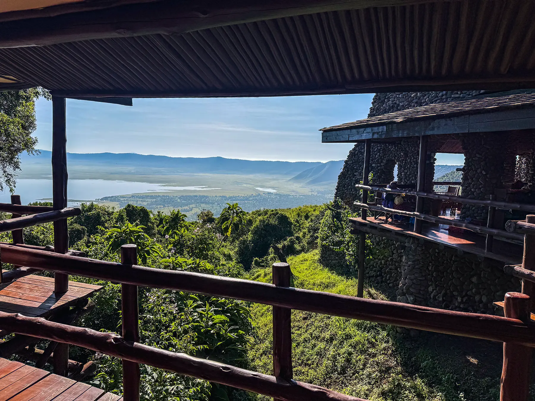 Wooden lodge terrace overlooking the forested crater rim and lake at the Ngorongoro Conservation Area, Tanzania