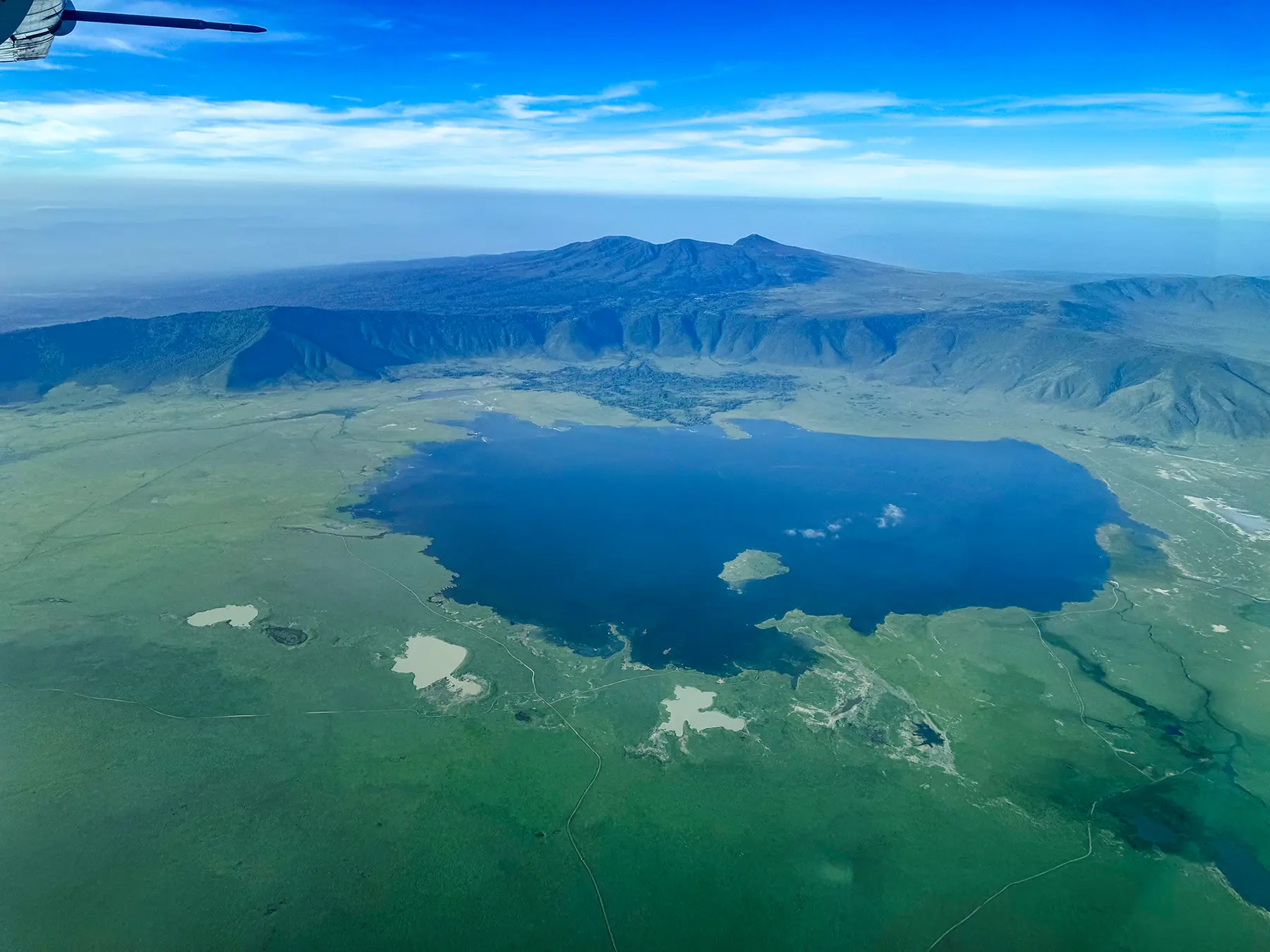 Aerial view of the Ngorongoro Crater with a lake inside and volcanic rim in Tanzania