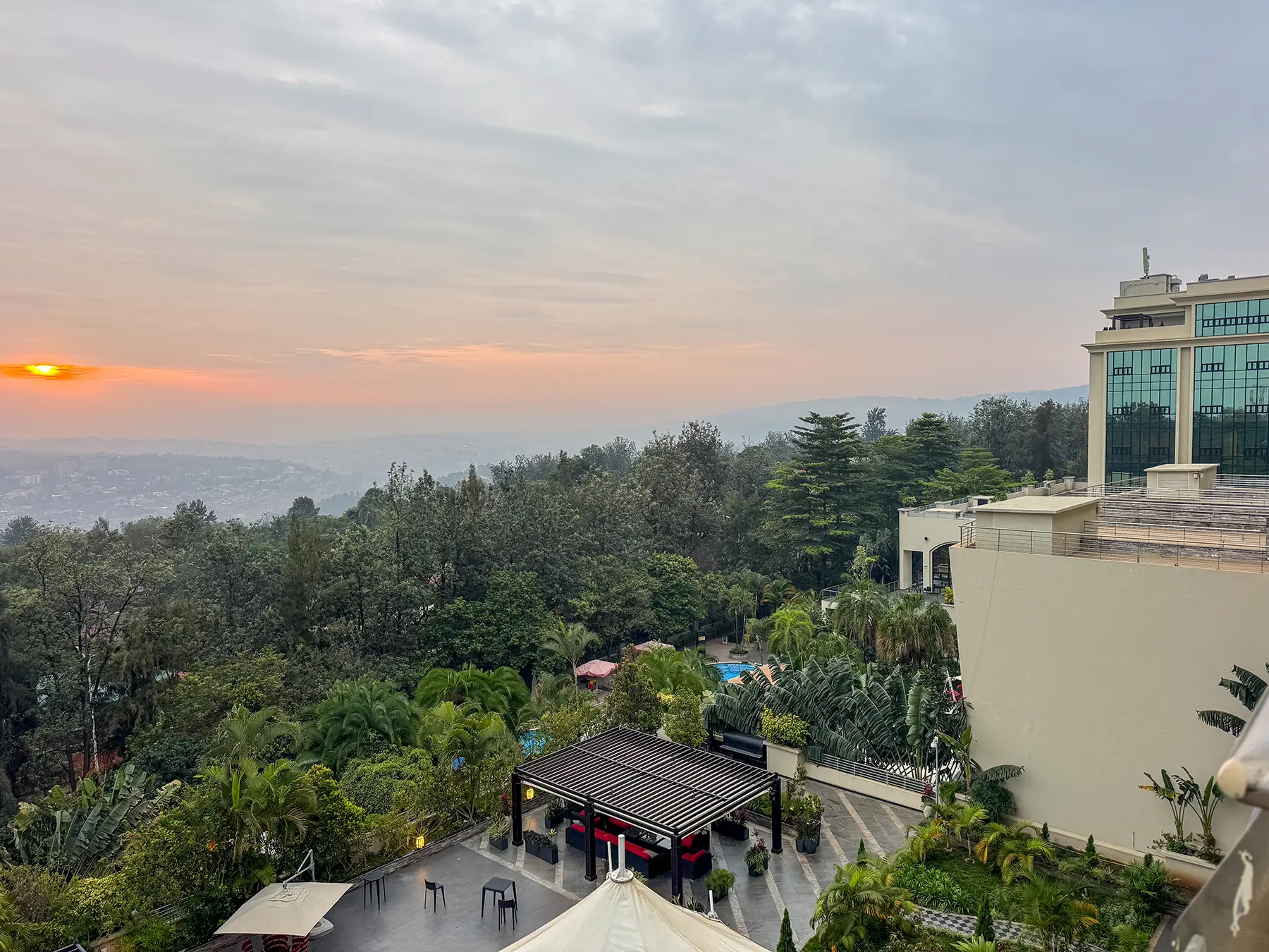 Sunset over Kigali hills with hotel grounds and gardens in foreground at Kigali Marriott in Kigali, Rwanda