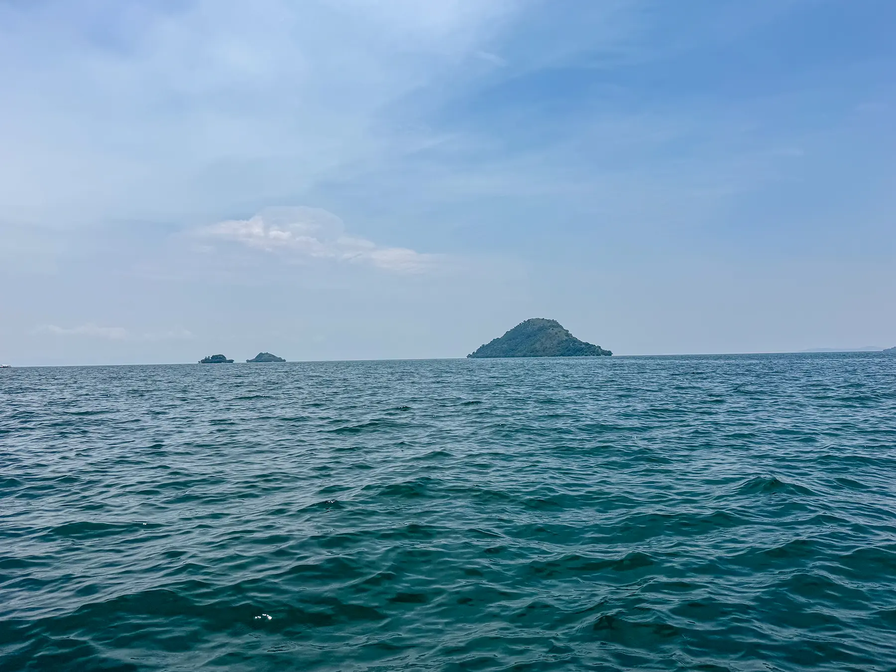 Forested islands rising from open water at Lake Kivu, Rwanda