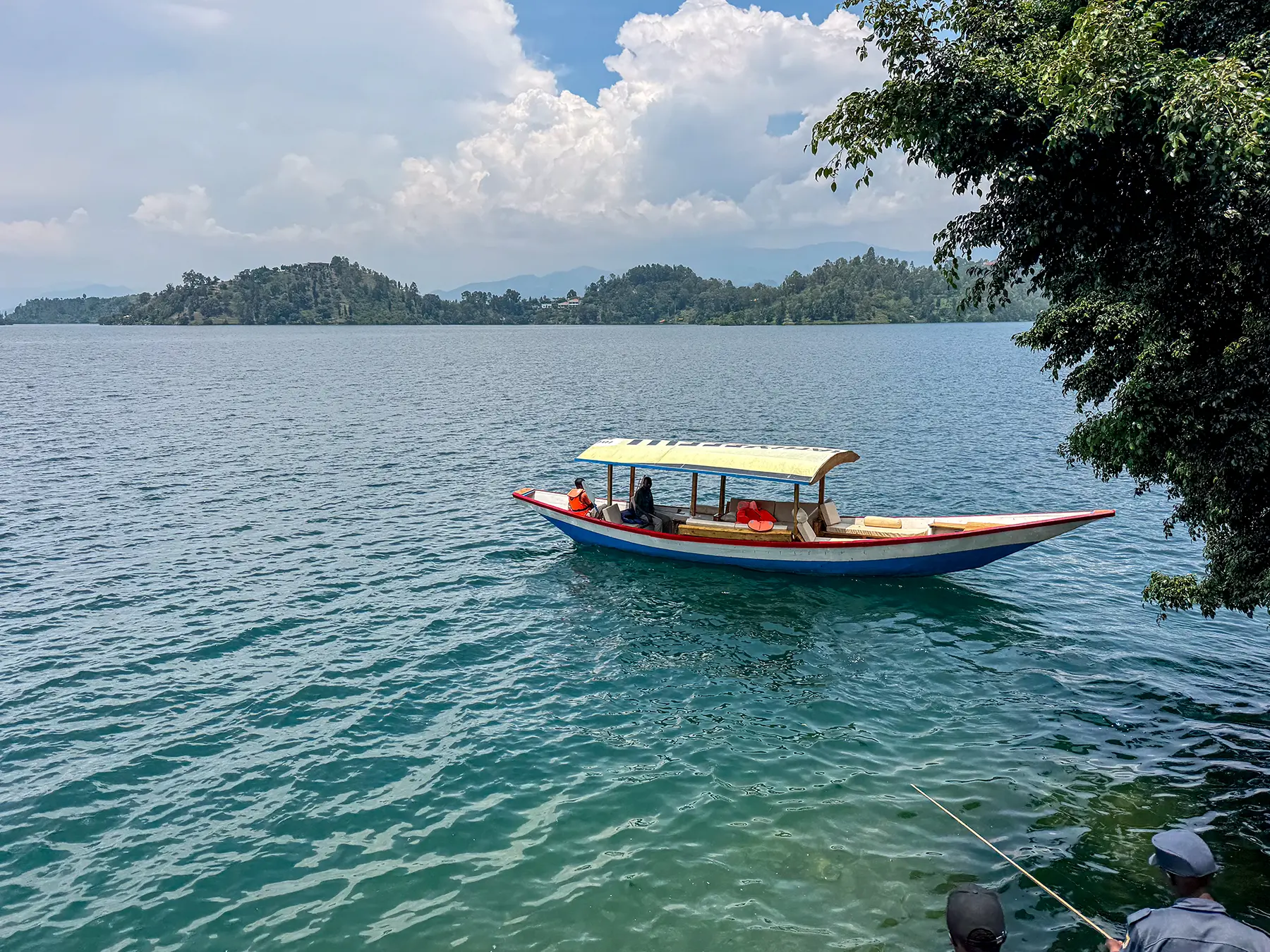 Colourful covered tour boat drifting on open water at Lake Kivu, Rwanda
