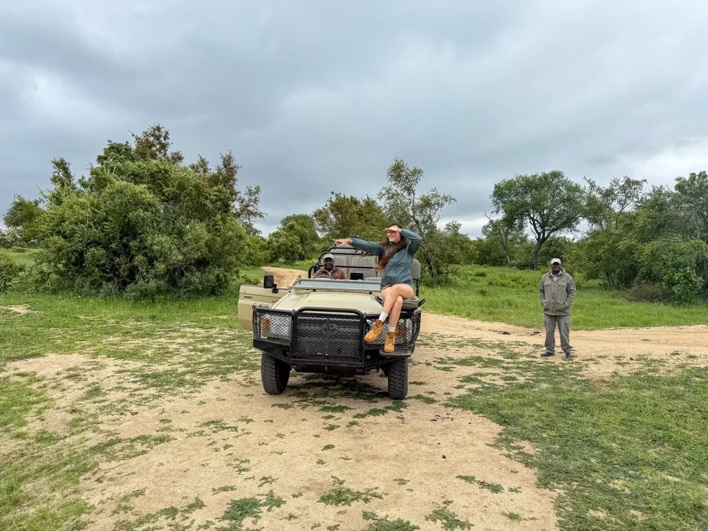 Ella McKendrick sitting on the front tracker seat of a Land Cruiser on safari in Sabi Sand Game Reserve, South Africa