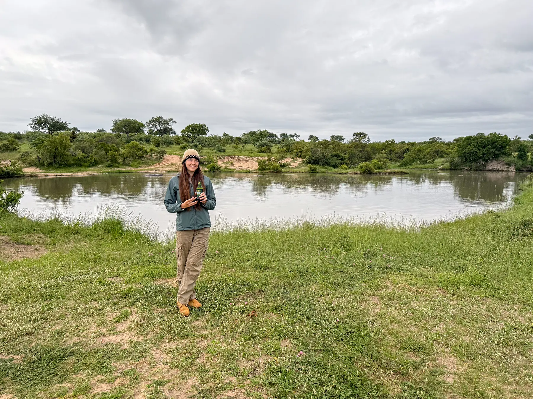 Ella McKendrick with a drink beside the river on safari in Sabi Sand Game Reserve, South Africa