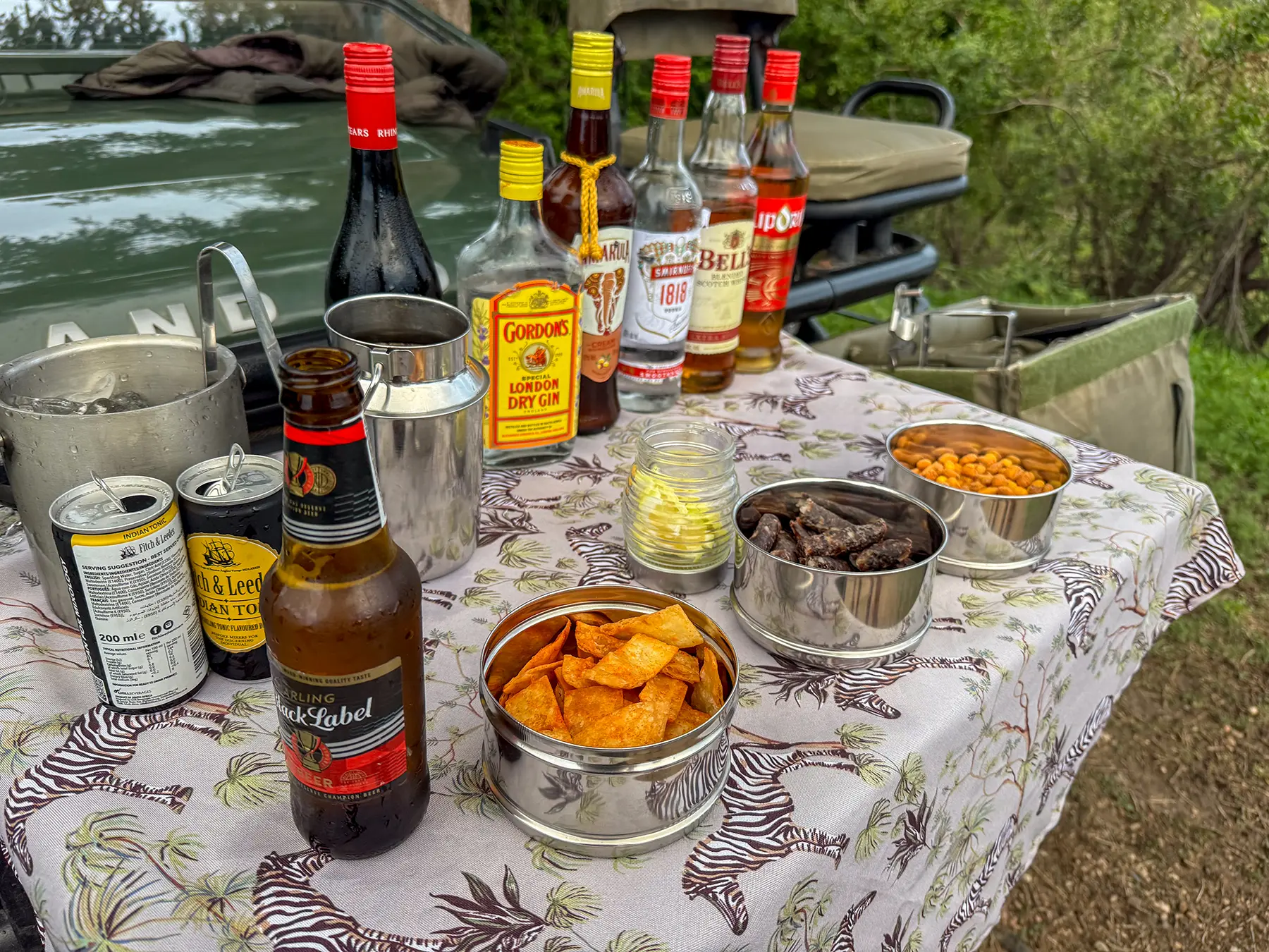 Beer, mixers and snack tins on a table at a game drive stop on safari in Timbavati Private Nature Reserve, South Africa