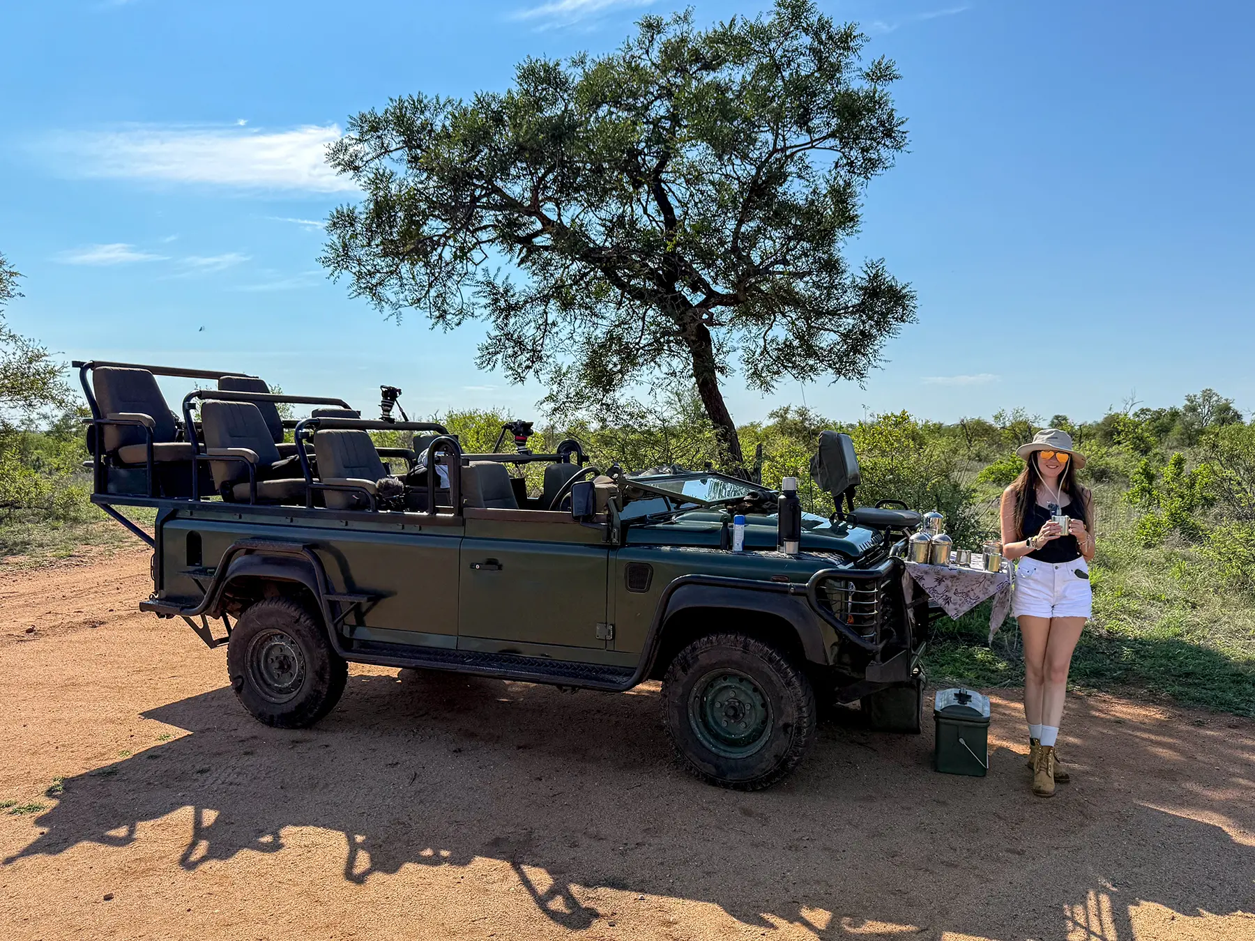 Ella McKendrick standing beside an open safari truck at a coffee stop on safari in Timbavati Private Nature Reserve, South Africa