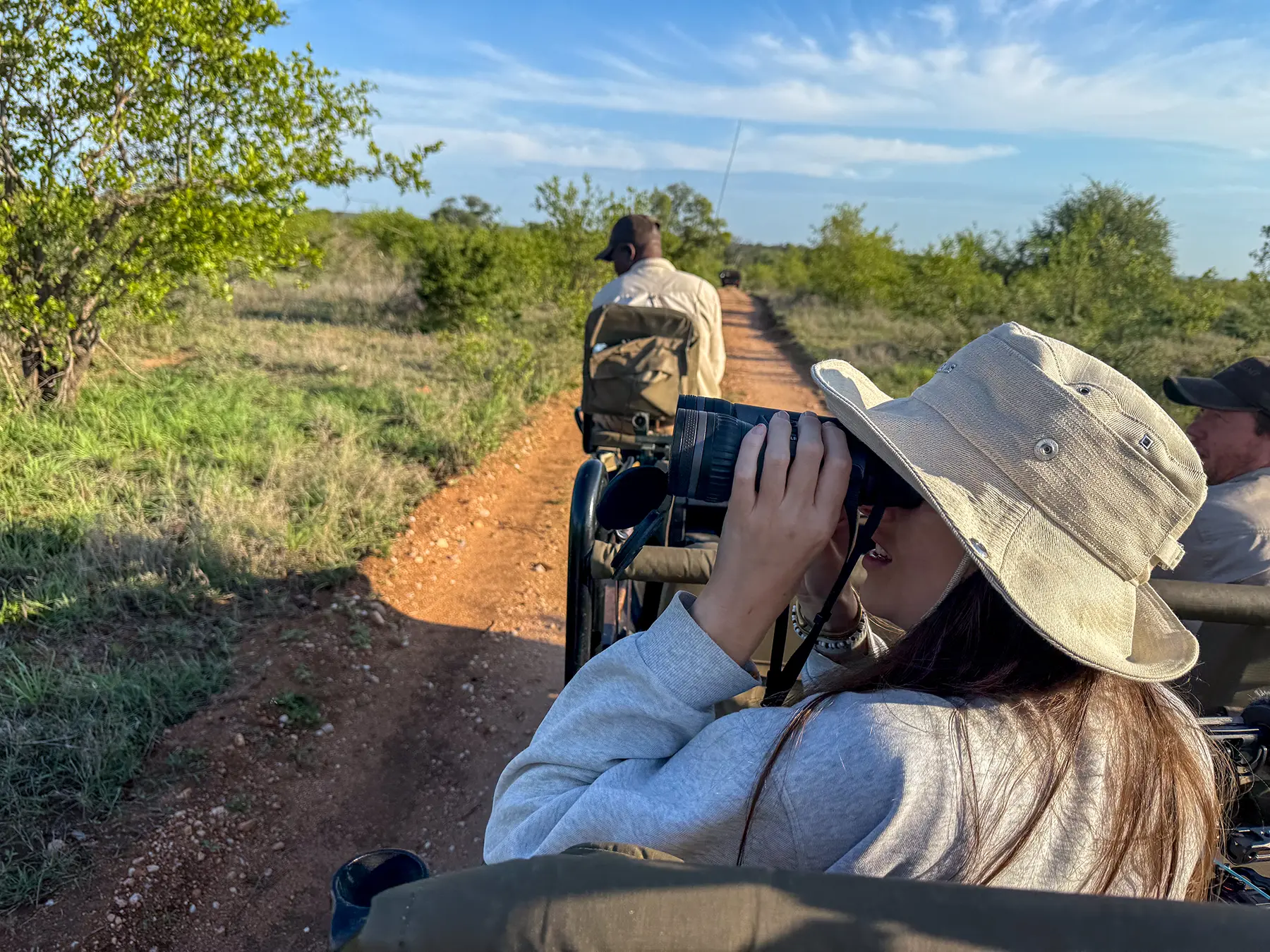 Ella McKendrick photographing through a telephoto lens from a safari truck on safari in Timbavati Private Nature Reserve, South Africa